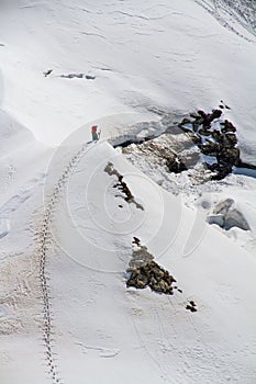 Skier climbing a snowy mountain