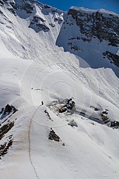 Skier climbing a snowy mountain