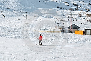 A skier climbs up the hill on a ski lift in winter in the ski centre of Antalya.