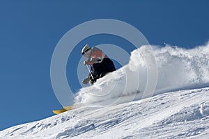 Skier in clouds of snow powder