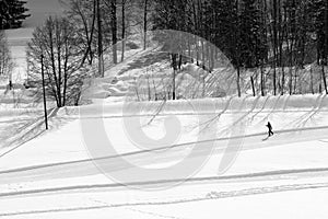 Skier cross-country skiing along the road in Grindelwald