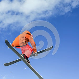Skier doing high jump above the mountain