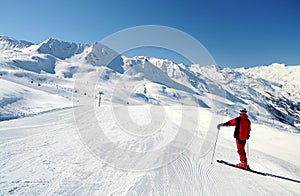 Skier enjoying mountain view at ski track