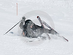 Skier fall on the ski slope.