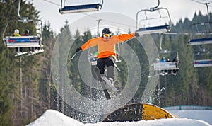 Skier flying over a hurdle in winter day