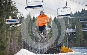 Skier flying over a hurdle in winter day