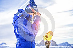 Skier getting ready to performing in alps mountains outdoor - Young athlete putting on ski sunglasses - Sport and winter vacation