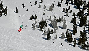 Skier going down the slopes on hi-speed at sunny day