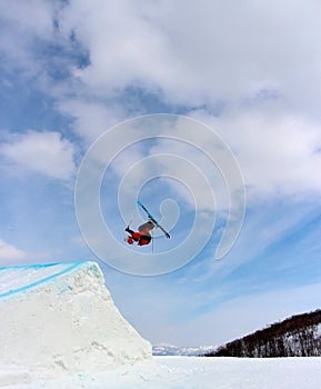 Skier going off a big jump in hanazono park