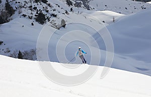 skier going off-piste on white snow in the mountains with the risk of avalanches