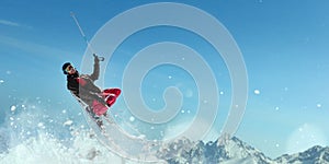 Skier in helmet and glasses makes a jump