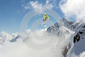 Skier jump in the mountains. Extreme ski sport. Freeride.