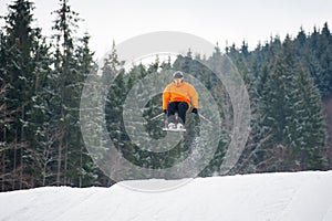 skier at jump from the slope of mountains