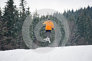 skier at jump from the slope of mountains