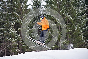 skier at jump from the slope of mountains