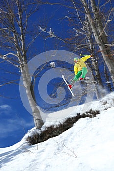 Skier jumping against blue sky