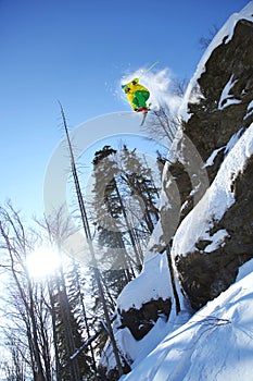 Skier jumping against blue sky