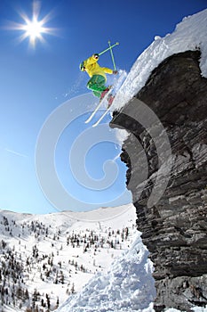 Skier jumping against blue sky