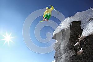 Skier jumping against blue sky