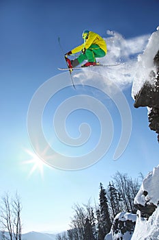 Skier jumping against blue sky