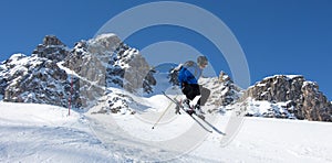 Skier jumping in front of rock mountains Meribel sun snowy mountain landscape France alpes 3 vallees