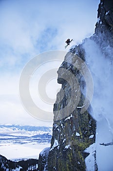 Skier Jumping From Mountain Cliff