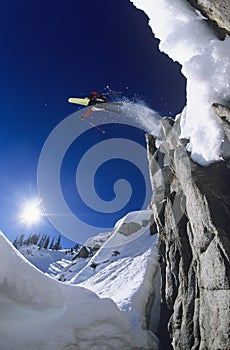 Skier Jumping From Mountain Cliff