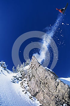 Skier Jumping From Mountain Ledge