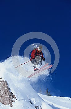 Skier Jumping From Mountain Ledge