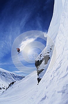 Skier Jumping From Mountain Ledge