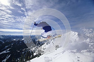 Skier Jumping On Mountain Top Hitting The Slopes