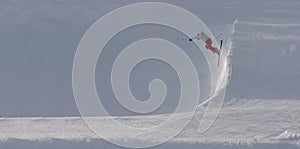 Skier jumping off steep slope