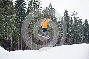 skier is jumping from the slope of mountains