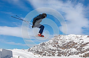 Skier jumps in the snowy mountains