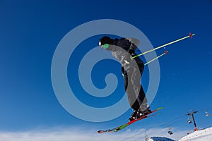 Skier jumps in the snowy mountains