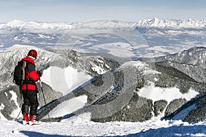 Skier looking at snowy winter mountains