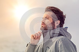 Skier man detail wearing anorak jacket. exploring snowy land walking and skiing with alpine ski. Europe Alps. Winter