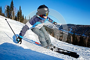 Skier man skiing downhill in high mountains