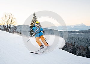 Skier man in snow powder produces braking on the slope of mountain