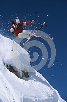 Skier In Midair Above Snow On Ski Slope