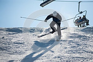 Skier in the moment of falling on the snowy slope