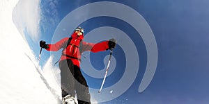 Skier in mountains performs a high speed turn on a ski piste