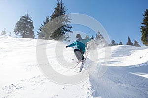 Skier in mountains, prepared piste and sunny day