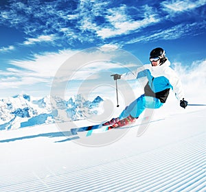 Skier in mountains, prepared piste and sunny day photo