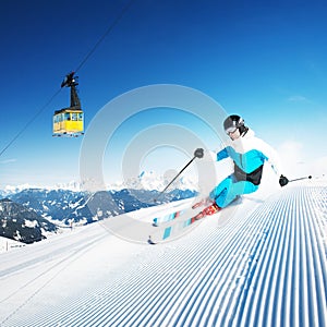 Skier in mountains, prepared piste and sunny day photo