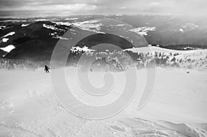 Skier in mountains, prepared piste and sunny day