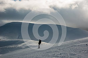 Skier in mountains, prepared piste and sunny day