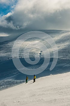 Skier in mountains, prepared piste and sunny day