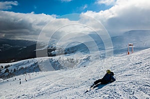 Skier in mountains, prepared piste and sunny day