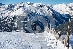 Skier next to the ski slopes, ready to go down the slope, Pyrenees, Grandvalira, Andorra.